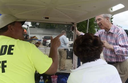 Democratic Senate candidate Dave Domina (R) greets Gary (L) and Jayne Arehart prior to a parade in the town of Elgin, Nebraska June 22, 2014. REUTERS/Darin Epperly