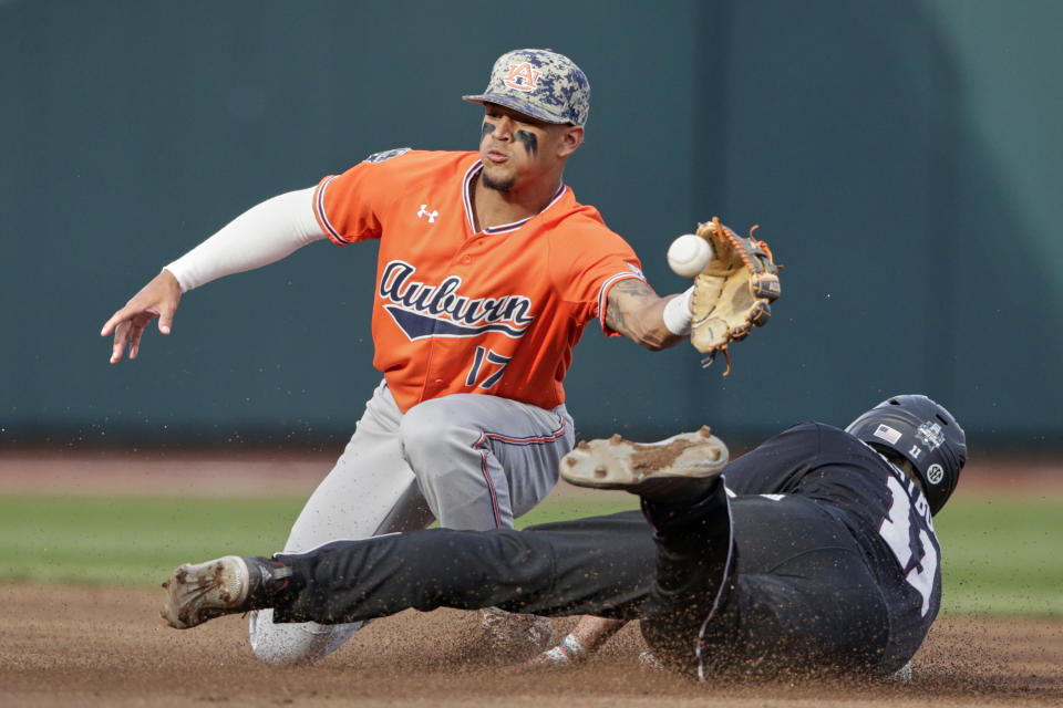 Mississippi State's Jordan Westburg (11) steals second base against Auburn shortstop Will Holland (17) in the first inning of an NCAA College World Series baseball game in Omaha, Neb., Sunday, June 16, 2019. (AP Photo/Nati Harnik)