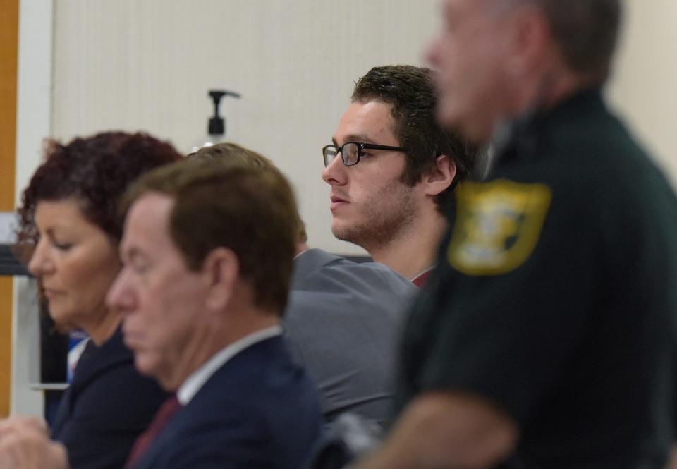 Austin Harrouff (background) sits with his legal team in court before Circuit Judge Sherwood Bauer at the Martin County Courthouse on Monday, Nov. 28, 2022 in Stuart, Fla.