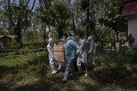 Indian paramilitary soldiers and an ambulance driver in blue carry the body of a paramilitary officer who died of COVID-19 for cremation in Srinagar, Indian controlled Kashmir, Tuesday, July 14, 2020. India is the third worst-affected nation by the coronavirus pandemic. (AP Photo/Dar Yasin)