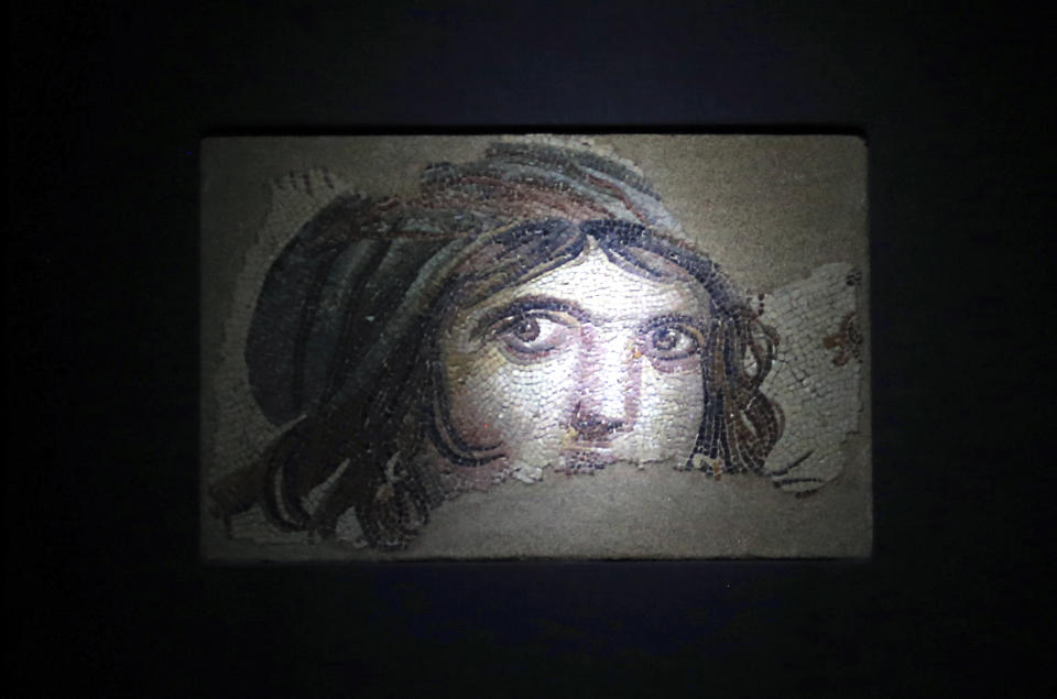 Part of a Roman-era mosaic, nicknamed "Gypsy Girl" that was found in the ancient city of Zeugma, is exhibited at the Zeugma Mosaic Museum, in Gaziantep, Turkey, Saturday, Dec. 8, 2018. Parts of the mosaic which were exhibited at a U.S. university's art collection were returned to Turkey, more than half a century after looters smuggled them out and are now displayed at the museum. Ohio's Bowling Green State University bought the 12 mosaics from a New York gallery in 1965. Turkish and Bowling Green officials agreed to their return in May 2018. (AP Photo/Emrah Gurel)