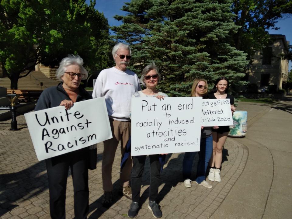 Standing Thursday on the square in New Philadelphia on the third anniversary of George Floyd's murder are Kathy Bachman, Jim Cox, Kathleen Cox, Laura Grimes and Laney Lanzer, left to right.