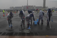 Municipal workers sweeps water off the street near Tiananmen Square in Beijing, China, on March 5, 2024. China’s first generation of migrant workers played an integral role in the country's transformation from an impoverished nation to an economic powerhouse. Now, they're finding it hard to find work, both because they're older and the economy is slowing. (AP Photo/Tatan Syuflana)