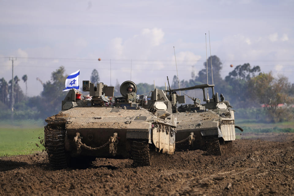 Israeli soldiers drive in their armored vehicles in southern Israel near the border with the Gaza Strip during ongoing ground operations, Friday, Feb. 2, 2024. (AP Photo/Tsafrir Abayov)