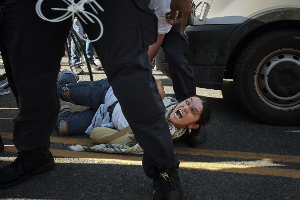 A pro-Palestinian demonstrator yells as a New York City police officer detains her during a protest demanding a permanent cease-fire in Gaza, Friday, May 31, 2024, in the Brooklyn borough of New York. (AP Photo/Andres Kudacki)