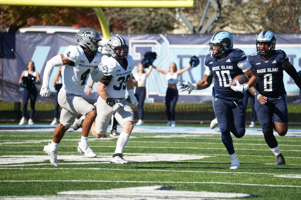 URI running back Ja'Den McKenzie gains ground against New Hampshire on Saturday. It was his 1-yard run in overtime that gave the Rams a 34-28 win.