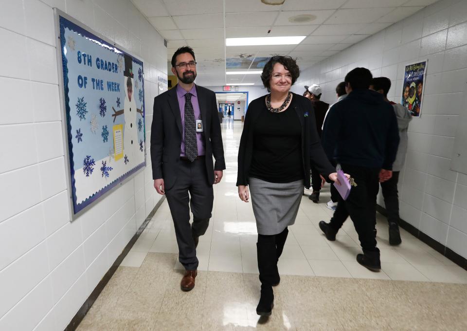 Gwen Snow, right, principal at the Newcomer Academy, and Justin Matson, director of ESL for JCPS, walk through the hallway at the school in Louisville, Ky. on Jan. 10, 2023. 