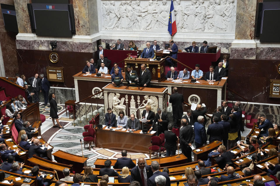 Far-right National Rally's Jose Gonzalez, center top, the oldest parliament member, chairs the National Assembly as parliament members vote to elect the house speaker , Tuesday, June 28, 2022 in Paris. France's National Assembly convenes for the first time since President Emmanuel Macron lost his parliamentary majority. (AP Photo/Michel Euler)