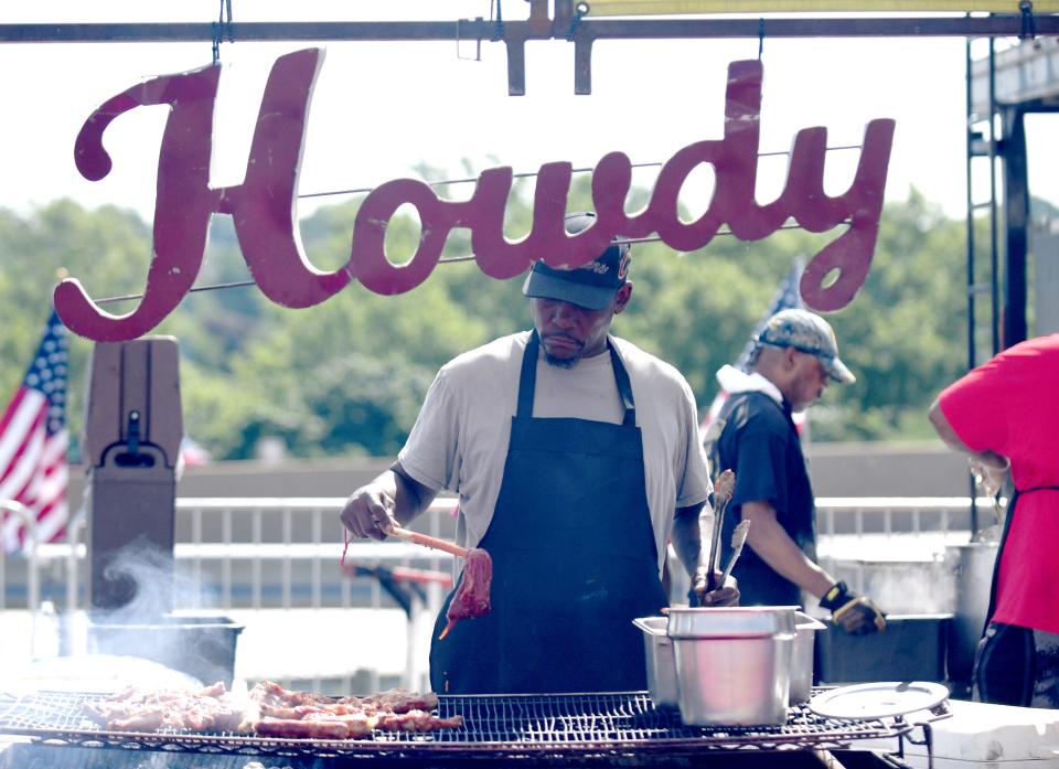 Dee Price, grillmaster with Cowboys Barbecue and Rib Company from Texas, works the grill during the 2024 Hall of Fame Ribs Burnoff.