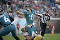 Jacksonville Jaguars quarterback Trevor Lawrence (16) is tackled by San Francisco 49ers defensive end Nick Bosa causing an interception during the second half of an NFL football game, Sunday, Nov. 12, 2023, in Jacksonville, Fla. (AP Photo/Phelan M. Ebenhack)
