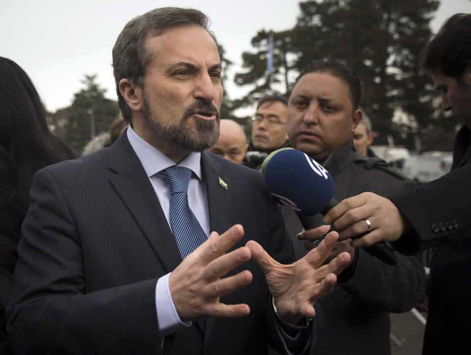 Louay Safi, spokesperson for the Syrian National Coalition, Syria's main political opposition group, gestures as he answers journalists questions at the United Nations headquarters in Geneva, Switzerland, Wednesday, Jan. 29, 2014. Syrian negotiators have resumed talks over the country's future a day after cutting short their discussions over a U.S. decision to resume aid to the opposition. (AP Photo/Anja Niedringhaus)