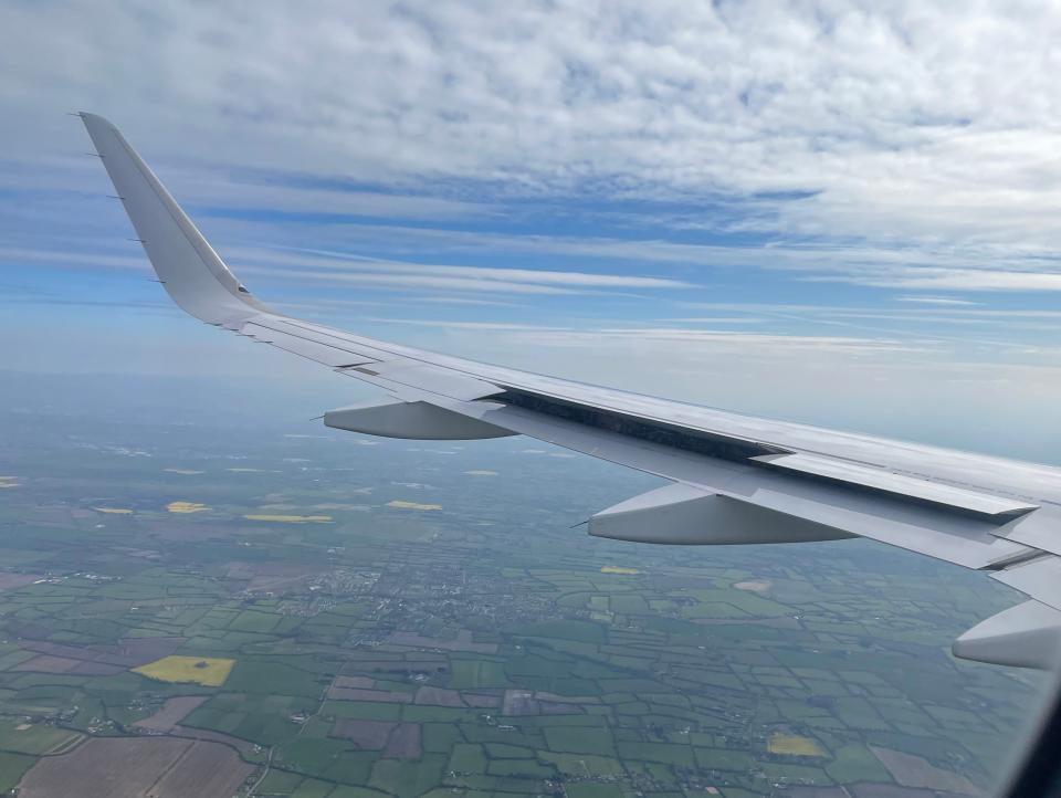 The view of a plane wing from a window seat.