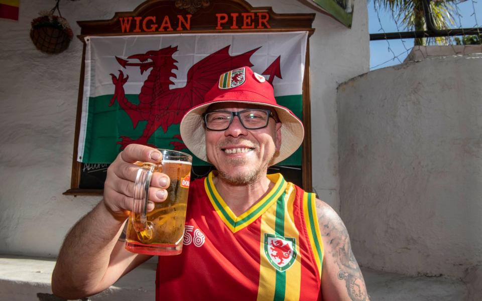 Wales fan Michael Exintaris, 45, a mechanic from Cardiff enjoys a pint at the Wigan Pier Bar in Tenerife - Julian Simmonds for The Telegraph