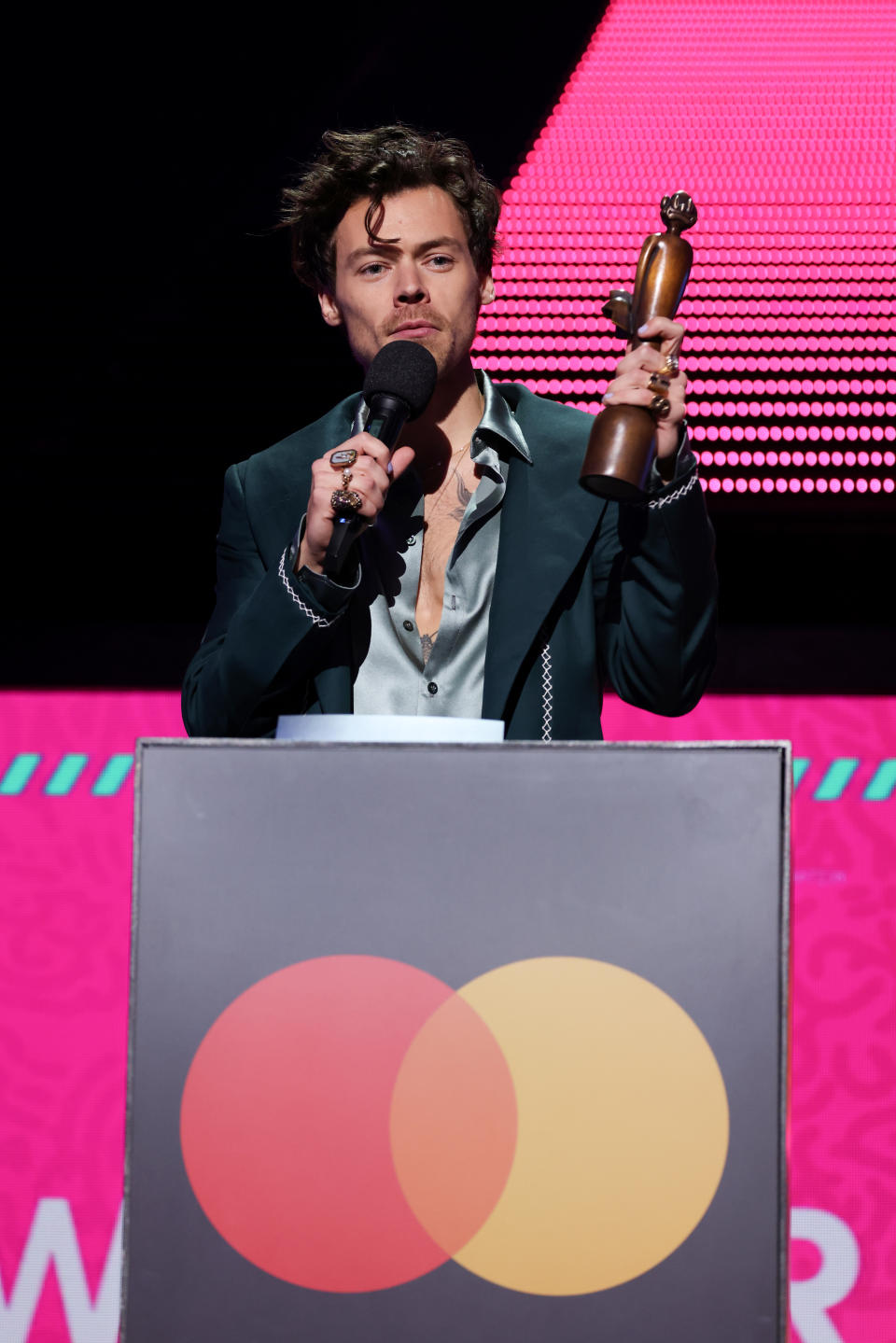 Harry Styles speaks on stage as they receive the award for Best Pop/R&B Act during The BRIT Awards 2023