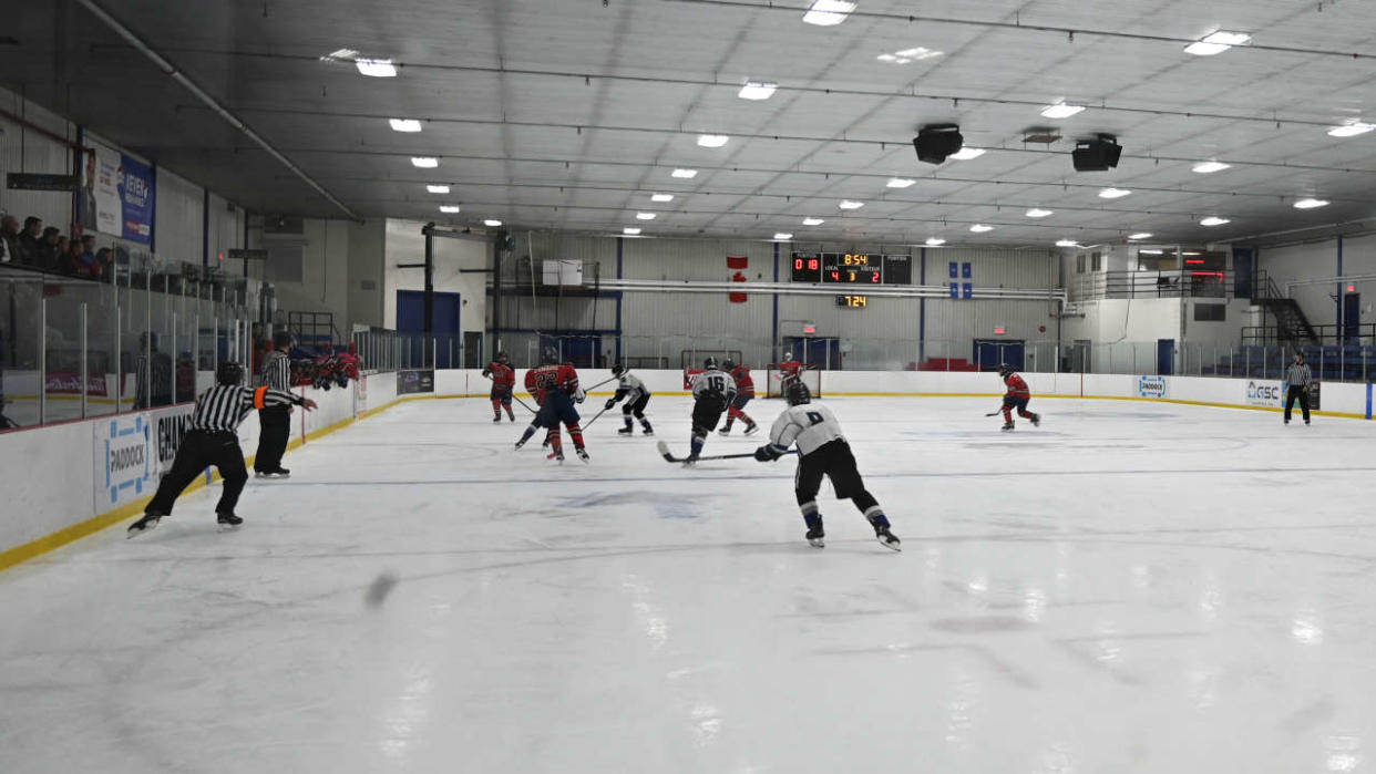 Ice hockey players chase the puck during a game at Arena La Plaine in Montreal on June 10, 2022. - True Canadian pride, ice hockey and especially its national federation are living dark hours in recent weeks, tarnished by a case of gang rape that resurfaces a culture of silence too long ignored. In May, Canadians were shocked to learn that eight players on the 2018 Junior National Team had been charged with gang sexual assault of a young woman. It was even more of a surprise when they learned that the organization supposedly overseeing them had allegedly tried to cover up the case by entering into a confidential multi-million dollar settlement with the victim. (Photo by Mathiew LEISER / AFP)