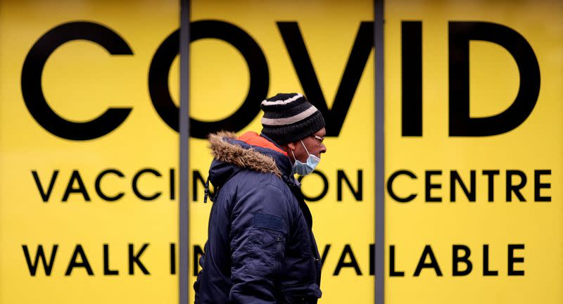 FILE PHOTO: Man walks past the Soho Pharmacy, in Birmingham