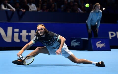 Greece's Stefanos Tsitsipas returns against Austria's Dominic Thiem during the men's singles final match on day eight of the ATP World Tour Finals tennis tournament at the O2 Arena in London on November 17, 2019. - Tsitsipas beat Austria's Dominic Thiem to win the match 6-7, 6-2, 7-6 - Credit: AFP