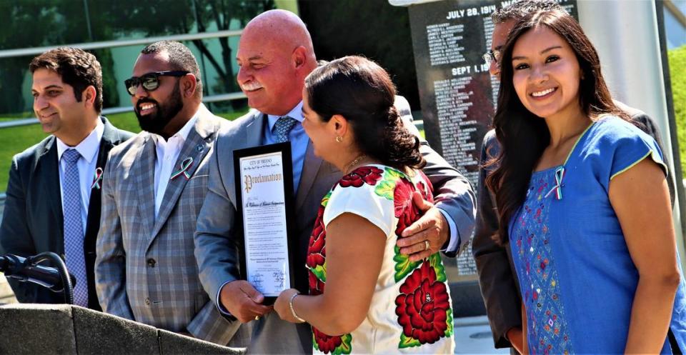 Fresno City Council Vice President Annalisa Perea, far right, glances as Mexican Consul General Adriana Gonzalez Carillo, center, is recognized by, from left, City Councilmembers Mike Karbassi and Nelson Esparza, Fresno Mayor Jerry Dyer and Councilmember Miguel Arias, partially obscured, during the Mexican Independence Day ceremony where the Mexican flag was raised at Fresno City Hall on Sept. 15, 2023.