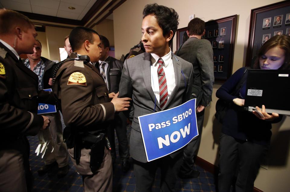 LGBT rights activist are detained by members of the Utah Highway Patrol after blocking a Senate committee hearing room at the Utah State Capitol, February 10, 2014, in Salt Lake City, Utah. LGBT rights activist are demanding the Legislature consider an anti-discrimination bill, Senate Bill 100, which the Senate has declined to do so. (REUTERS/Jim Urquhart)