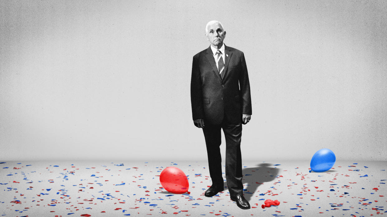  Mike Pence standing amid confetti and balloons. 