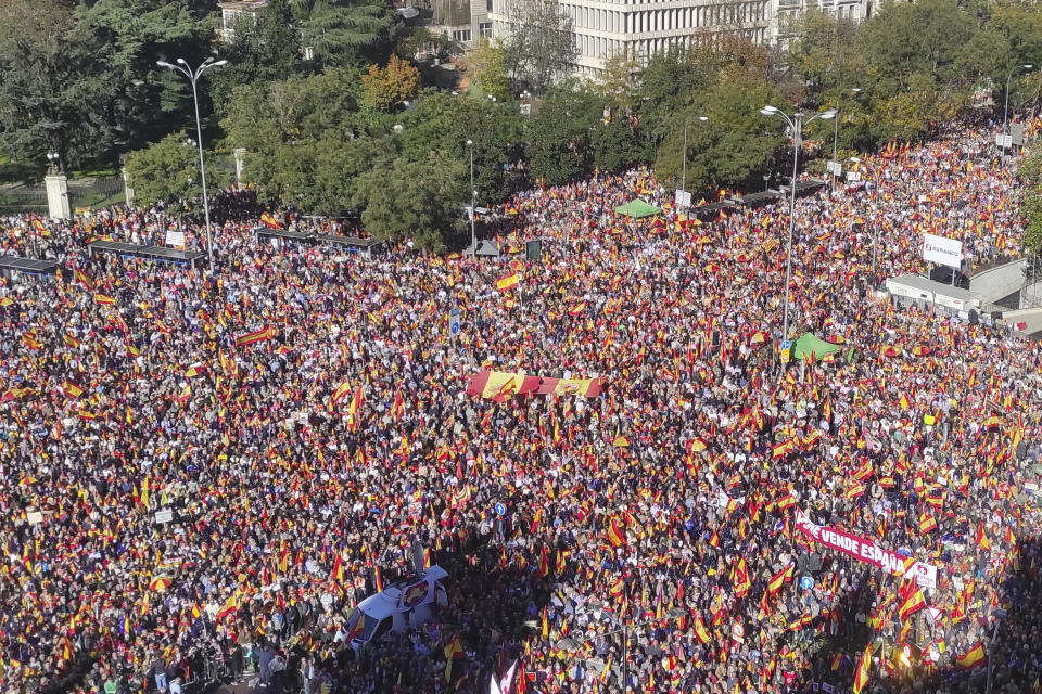 FILE - Protesters pack the central Cibeles square in Madrid, Spain, Saturday, Nov. 18, 2023, during a demonstration against a potential amnesty law. Spain's lower house of Parliament is Tuesday to debate and likely approve an enormously controversial amnesty law that aims to sweep away the legal troubles of hundreds of people, involved in Catalonia's unsuccessful 2017 independence bid. A key question is whether a Catalan separatist party manages to include clauses that cover terrorism that will guarantee protection for fugitive leader Carles Puigdemont. (AP Photo/Alicia Leon, File)
