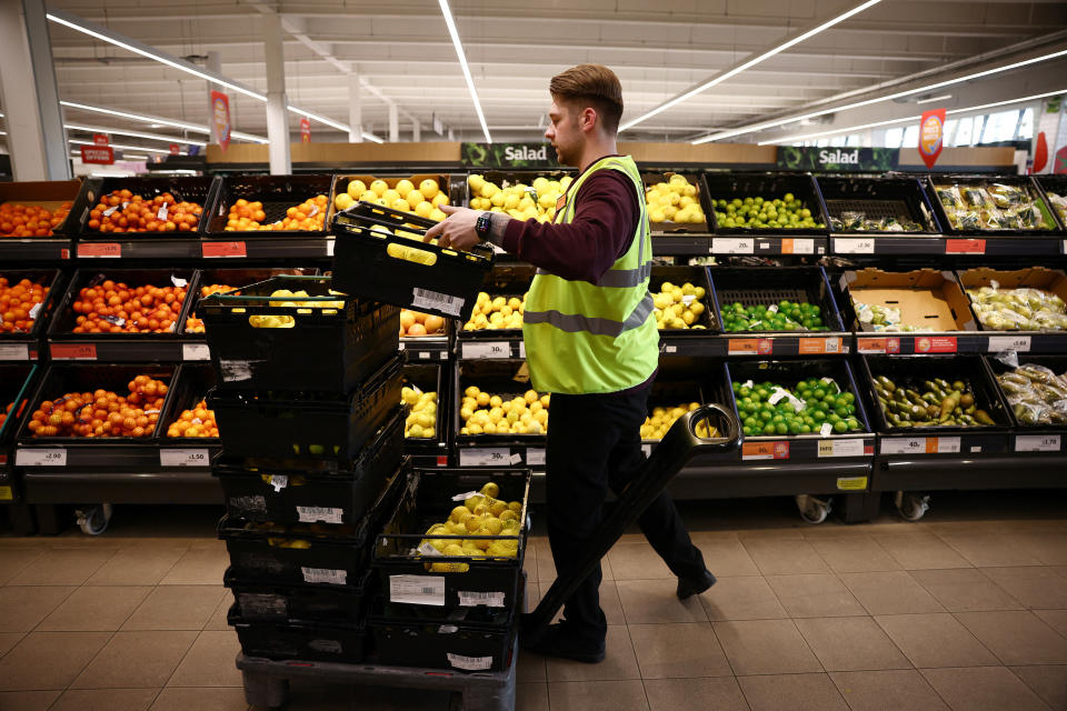 Sainsbury's A employee arranges produce inside a Sainsbury’s supermarket in Richmond, west London, Britain, June 27, 2022. Picture taken June 27, 2022. REUTERS/Henry Nicholls