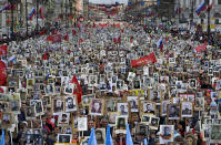 <p>Local residents carry portraits of their ancestors, participants in World War II as they celebrate the 72nd anniversary of the defeat of the Nazis in World War II in St. Petersburg, Russia, on May 9, 2017. About 400,000 people walked in central streets of St. Petersburg in a march named ‘Immortal Regiment’ while carrying portraits of their relatives who fought in World War II. (Photo: Dmitri Lovetsky/AP) </p>