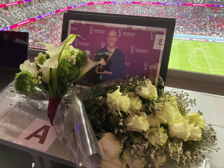A tribute to journalist Grant Wahl is seen on his previously assigned seat at the World Cup quarterfinal soccer match between England and France, at the Al Bayt Stadium in Al Khor, Qatar, Saturday, Dec. 10, 2022. Wahl, one of the most well-known soccer writers in the United States, died early Saturday Dec. 10, 2022 while covering the World Cup match between Argentina and the Netherlands. (AP Photo/Graham Dunbar)