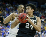 <p>Wofford forward Keve Aluma (24) looks for a path to the basket against Kentucky’s Keldon Johnson during the first half of a second-round game in the NCAA men’s college basketball tournament in Jacksonville, Fla., Saturday, March 23, 2019. (AP Photo/Stephen B. Morton) </p>