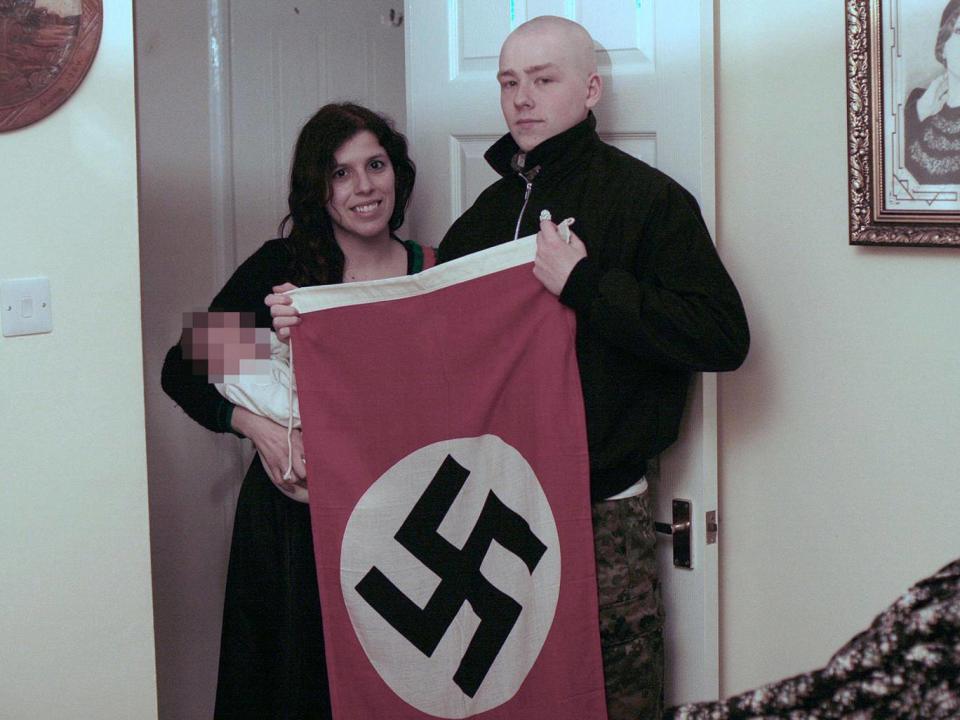 Adam Thomas and Claudia Patatas posed for pictures with their son alongside a Nazi flag (PA)