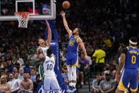 Dallas Mavericks' Dorian Finney-Smith (10) and Dwight Powell, left rear, defend against a shot by Golden State Warriors guard Stephen Curry (30) in the first half of an NBA basketball game in Dallas, Thursday, March, 3, 2022. (AP Photo/Tony Gutierrez)
