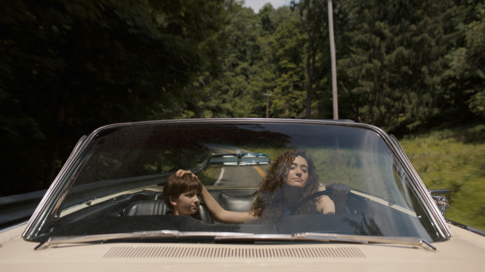 Image of a woman and child in an open-top car