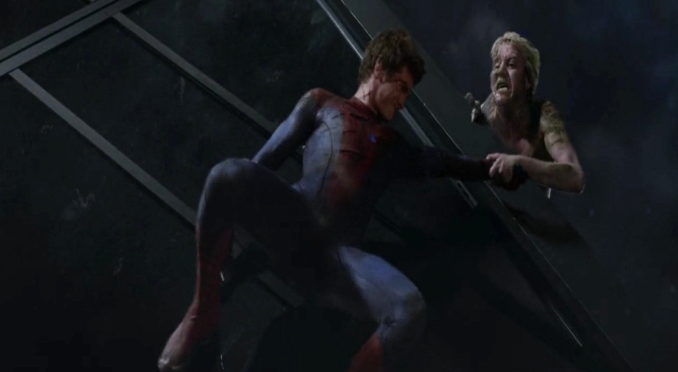 Dr Curt Connors holds Spider-Man's hand in order to prevent the latter from falling to his death