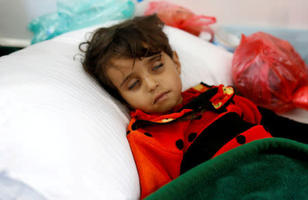 FILE PHOTO: A girl infected with cholera lies on the ground at a hospital in Sanaa, Yemen May 7, 2017. REUTERS/Khaled Abdullah/File Photo