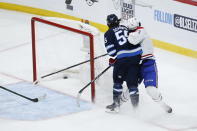 Winnipeg Jets' Mark Scheifele (55) hits Montreal Canadiens' Jake Evans (71) after Evans scored an empty-net goal during the third period of Game 1 of an NHL hockey Stanley Cup second-round playoff series Wednesday, June 2, 2021, in Winnipeg, Manitoba. (John Woods/The Canadian Press via AP)