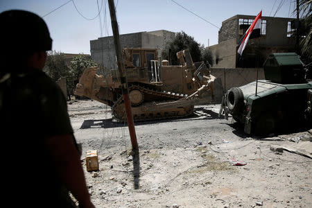 A bulldozer of the Iraqi rapid response forces moves to clear the frontline during clashes with Islamic State fighters in western Mosul, Iraq May 27, 2017. REUTERS/Alkis Konstantinidis