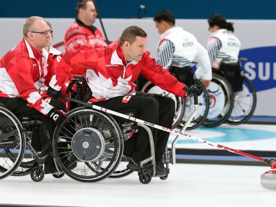 Mark Ideson, right, helped lead Canada to two dominant wins at the world wheelchair curling championship in Beijing on Wednesday. (Twitter/@CDNParalympics - image credit)