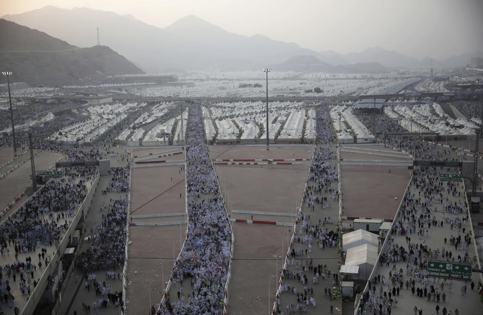 <p>Muslim pilgrims walk from their camps in Mina to cast stones at three huge stone pillars in the symbolic stoning of the devil, outside the holy city of Mecca, Saudi Arabia, Saturday, Sept. 2, 2017. (Photo: Khalil Hamra/AP) </p>