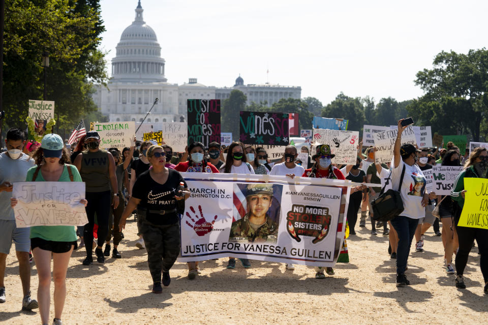 FILE - In this July 30, 2020 file photo, supporters of the family of slain Army Spc. Vanessa Guillen march to the White House along the National Mall as Capitol Hill is seen in the distance after a news conference, in Washington. Current and former soldiers at Fort Hood, have taken to social media to report accounts of sexual assault and harassment following the disappearance and slaying this year of Guillen, whose family members say was harassed by the officer who eventually killed her. (AP Photo/Carolyn Kaster, File)