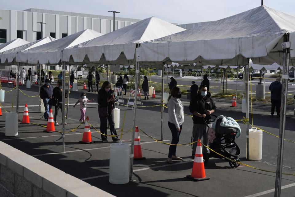 People line up at a COVID-19 walk-up testing site on the Martin Luther King Jr. Medical Campus Thursday, Jan. 7, 2021, in Los Angeles. (AP Photo/Marcio Jose Sanchez)