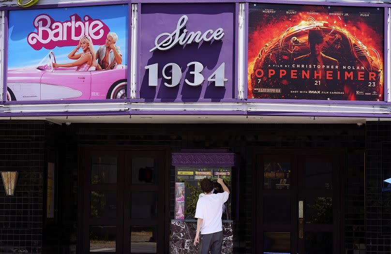 A patron buys a movie ticket at the Los Feliz Theatre, July 28, 2023, in Los Angeles