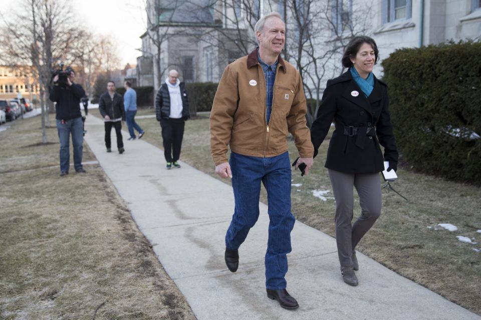 Illinois Republican gubernatorial candidate Bruce Rauner, center, and his wife, Diana Rauner, head home after voting on Tuesday, March 18, 2014, in Winnetka, Ill. Rauner faces State Sen. Bill Brady, State Sen. Kirk Dillard and State Treasurer Dan Rutherford in the primary election. (AP Photo/Andrew A. Nelles)