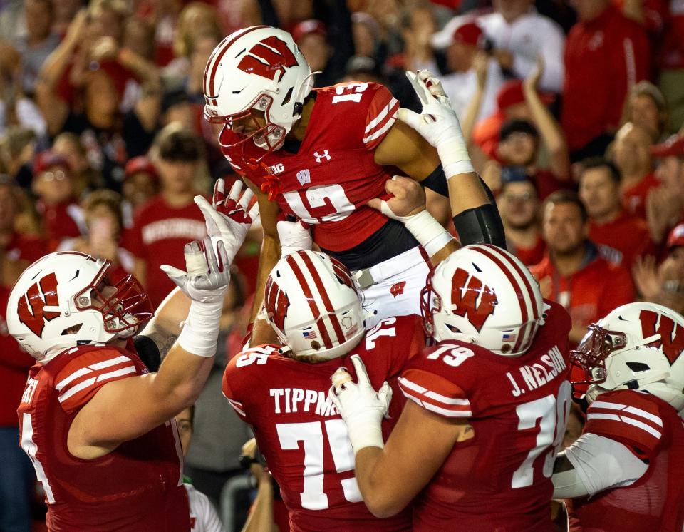 Wisconsin Badgers wide receiver Chimere Dike (13) celebrates with teammates after scoring a touchdown in the third quarter of the game against the Illinois State Redbirds.