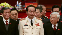 FILE PHOTO: Vietnam's Public Security (Police) Minister General Tran Dai Quang (C) stands with Communist Party's General Secretary Nguyen Phu Trong (R) and Politburo member Dinh The Huynh (L) at a closing ceremony of 12th National Congress of the Party in Hanoi, January 28, 2016. REUTERS/Kham/File Photo