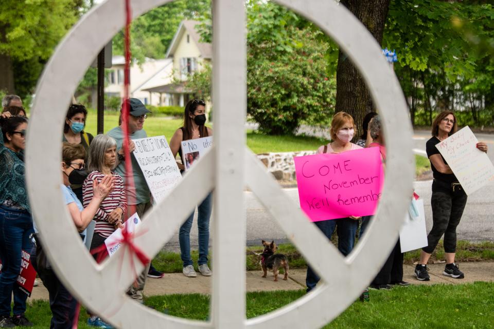 Lakeland Unitarian Universalist Fellowship in Wayne, NJ partnered with Planned Parenthood to be a demonstration site as part of a Nationwide protest for Women's Right to Choose on Saturday May 14, 2022. A peace sign frames people holding protest signs. 