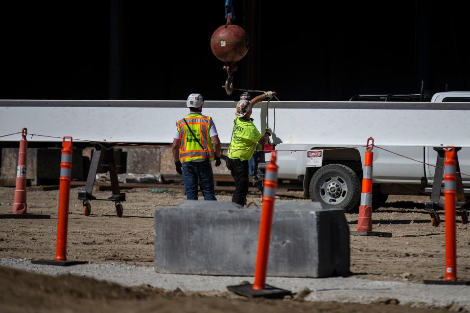 A crew from Turner Construction places the last structural beam of the Des Moines University Innovation Building on the new campus under-construction in West Des Moines, on Wednesday, Sep. 22, 2021. The campus is expected to be ready in the fall of 2023. 