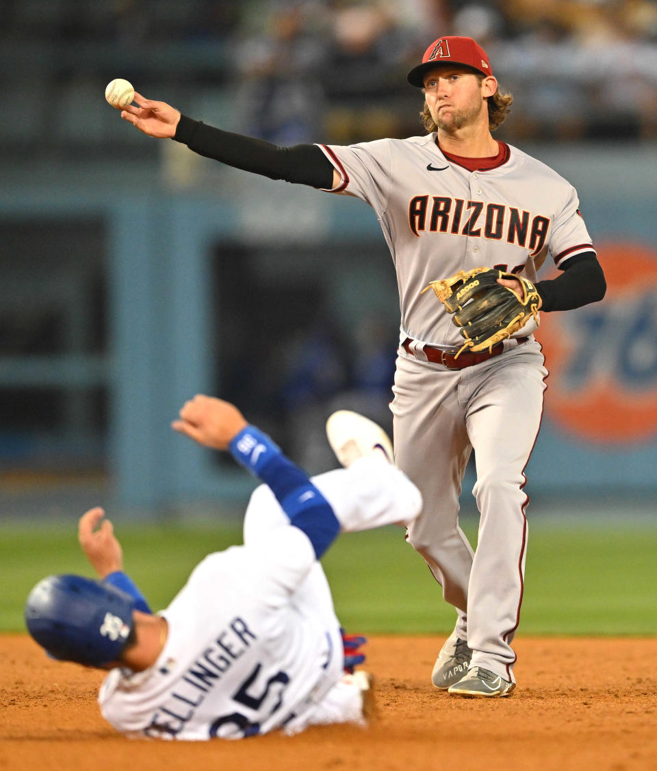 May 17, 2022; Los Angeles, California, USA;  Arizona Diamondbacks right fielder Jake Hager (16) throws to first as Los Angeles Dodgers center fielder Cody Bellinger (35) is out on a double play in the seventh inning at Dodger Stadium. Mandatory Credit: Jayne Kamin-Oncea-USA TODAY Sports