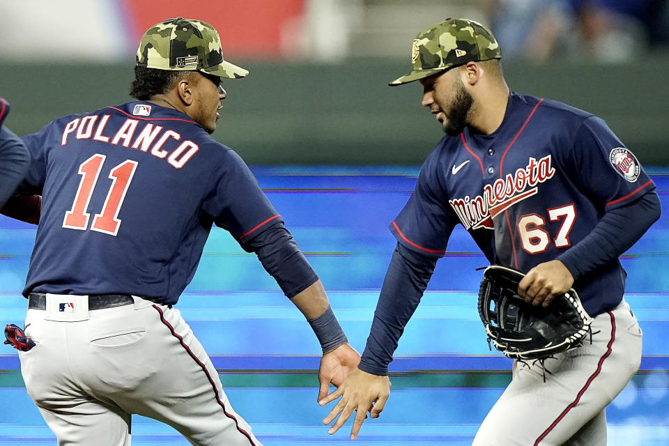 Minnesota Twins' Jorge Polanco (11) and Gilberto Celestino (67) celebrate after their baseball game against the Kansas City Royals Friday, May 20, 2022, in Kansas City, Mo. The Twins won 6-4.(AP Photo/Charlie Riedel)