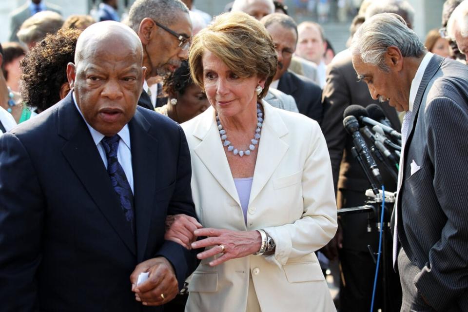 U.S. House Minority Leader Rep. Nancy Pelosi (D-CA) (2nd L) is escorted by Rep. John Lewis (D-GA) (L) during a news conference after a walkout in protest of a vote on whether <span class="caas-xray-inline-tooltip"><span class="caas-xray-inline caas-xray-entity caas-xray-pill rapid-nonanchor-lt" data-entity-id="Eric_Holder" data-ylk="cid:Eric_Holder;pos:3;elmt:wiki;sec:pill-inline-entity;elm:pill-inline-text;itc:1;cat:OfficeHolder;" tabindex="0" aria-haspopup="dialog"><a href="https://search.yahoo.com/search?p=Eric%20Holder" data-i13n="cid:Eric_Holder;pos:3;elmt:wiki;sec:pill-inline-entity;elm:pill-inline-text;itc:1;cat:OfficeHolder;" tabindex="-1" data-ylk="slk:Attorney General Eric Holder;cid:Eric_Holder;pos:3;elmt:wiki;sec:pill-inline-entity;elm:pill-inline-text;itc:1;cat:OfficeHolder;" class="link ">Attorney General Eric Holder</a></span></span> was in contempt of Congress June 28, 2012 on Capitol Hill in Washington, DC. (Photo by Alex Wong/Getty Images)