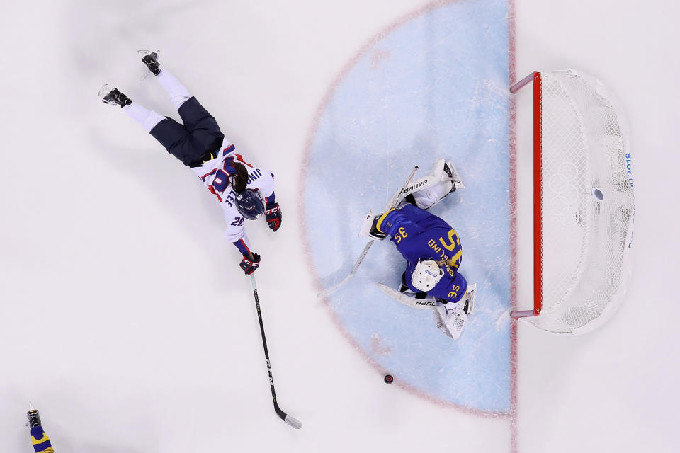 <p>Jingyu Lee #29 of Korea dives for the puck against Sarah Berglind #35 of Sweden in the third period during the Women’s Classifications game on day eleven of the PyeongChang 2018 Winter Olympic Games at Kwandong Hockey Centre on February 20, 2018 in Gangneung, South Korea. (Photo by Harry How/Getty Images) </p>